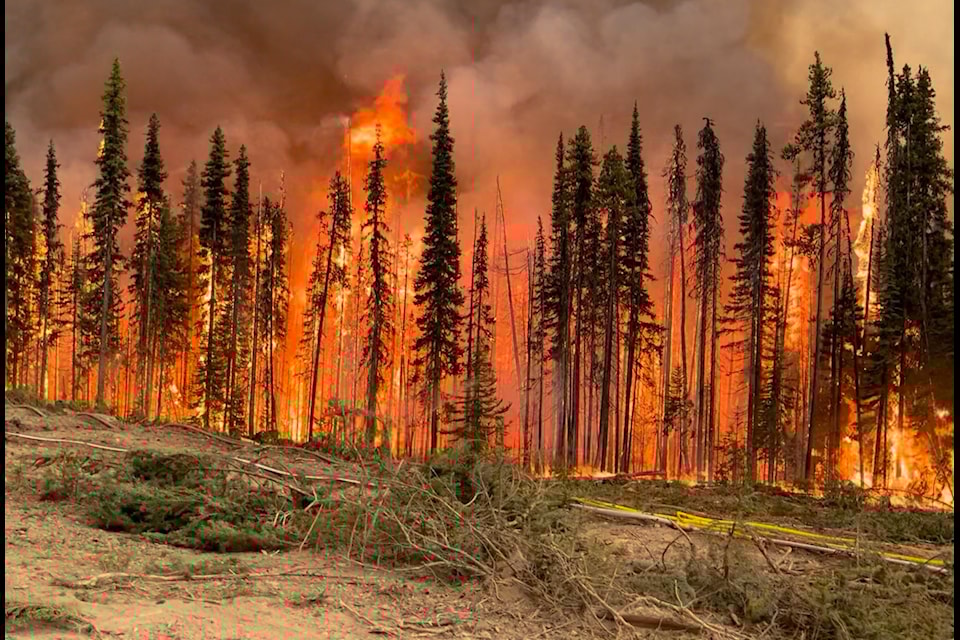 A Cheslatta Nation crew member captures a blaze inside the perimeter of the Tweedsmuir Park.
