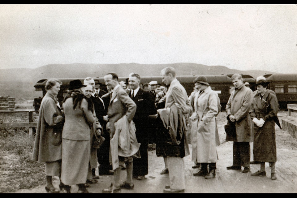 Lord Tweedsmuir (left, light coloured overcoat over arm) greets well-wishers at the  Lake railway station in August 1937.