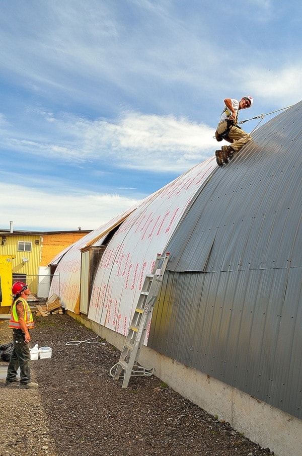 Curved roof means short leash for arena roofers