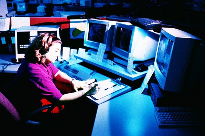 Woman working at police dispatch terminal