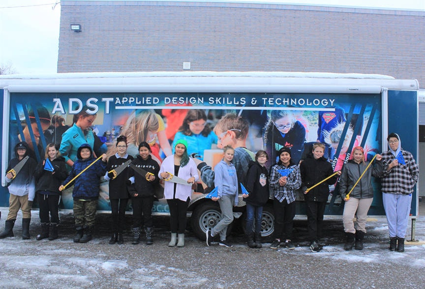 WKE students pose with carpentry tools in front of the ADST trailer that will allow the school to have a fully operational mobile wood shop. (Karen Ware photo/Lakes District News)