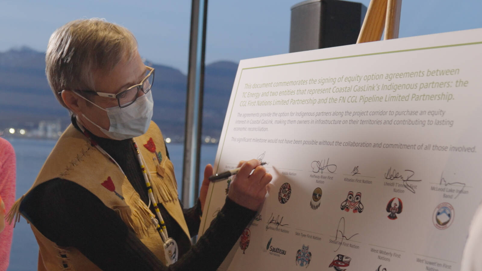 Chief Corrina Leween, Cheslatta Carrier Nation, signs commemoration document.