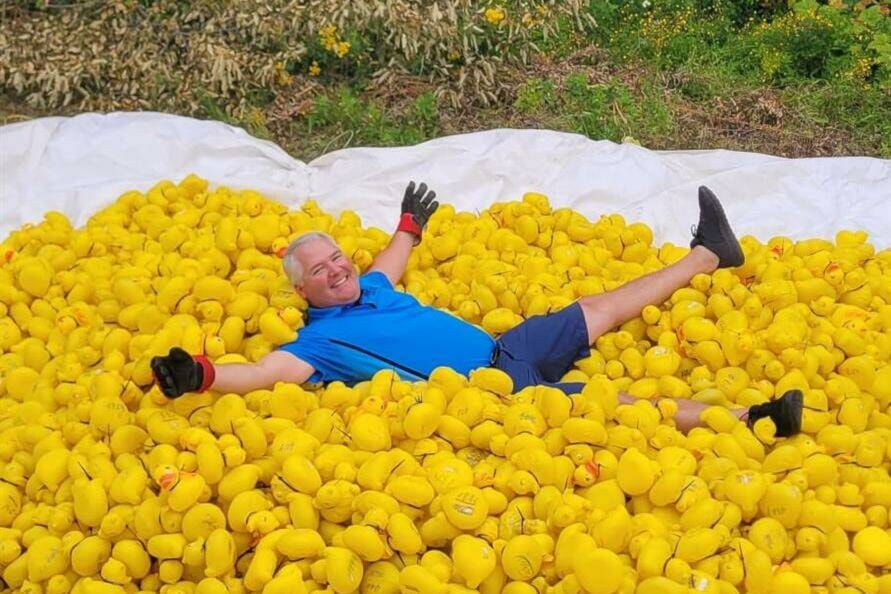 Terrace Rotary Club President Chad Sallenback revels in a pile of rubber ducks, celebrating the success of the 2023 Terrace Rotary Club Wild Duck Race on Aug. 7, a beloved part of Terrace’s Riverboat Days festivities. (Terrace Rotary Club photo)
