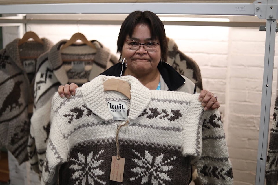 Zena Roland holds a knitted Cowichan sweater she made for the Knit launch. (Photo courtesy of VNFC)