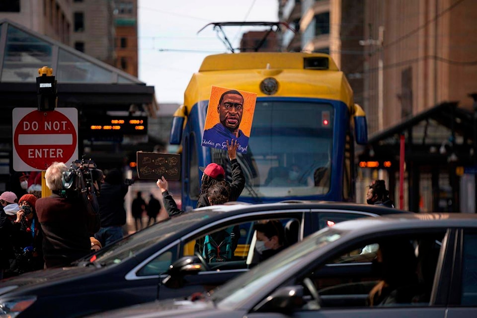 A light rail train is blocked briefly by demonstrators next to the plaza at Hennepin County Government Center on the eve of the start of the trial of Derek Chauvin in the killing of George Floyd, Sunday, March 28, 2021, in Minneapolis. (Jeff Wheeler/Star Tribune via AP)