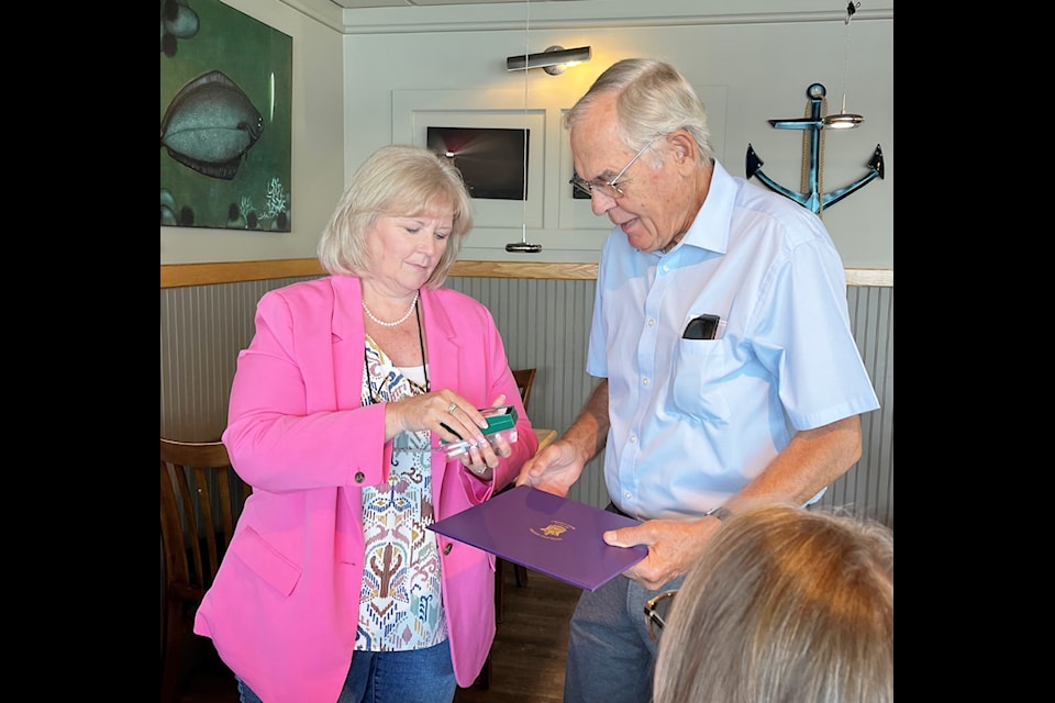 Colin Gabelmann accepts the King Charles III Coronation Medal from North Island MLA Michele Babchuk on Sep. 4.
