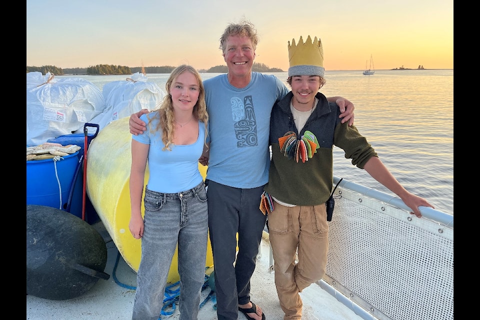 Maese Shea, 16, her father Greg Shea, 51, and Mowat Shea, 18, pose for a photo on the Cascadia’s helideck, where marine debris was sorted and stored. 