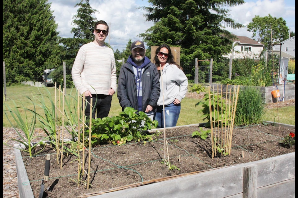Jeff Groat, outreach and food security organizer for Greenways, with Chris and Laureen Wood, the community inclusion worker with Communitas, at the Mountain View Community Garden.