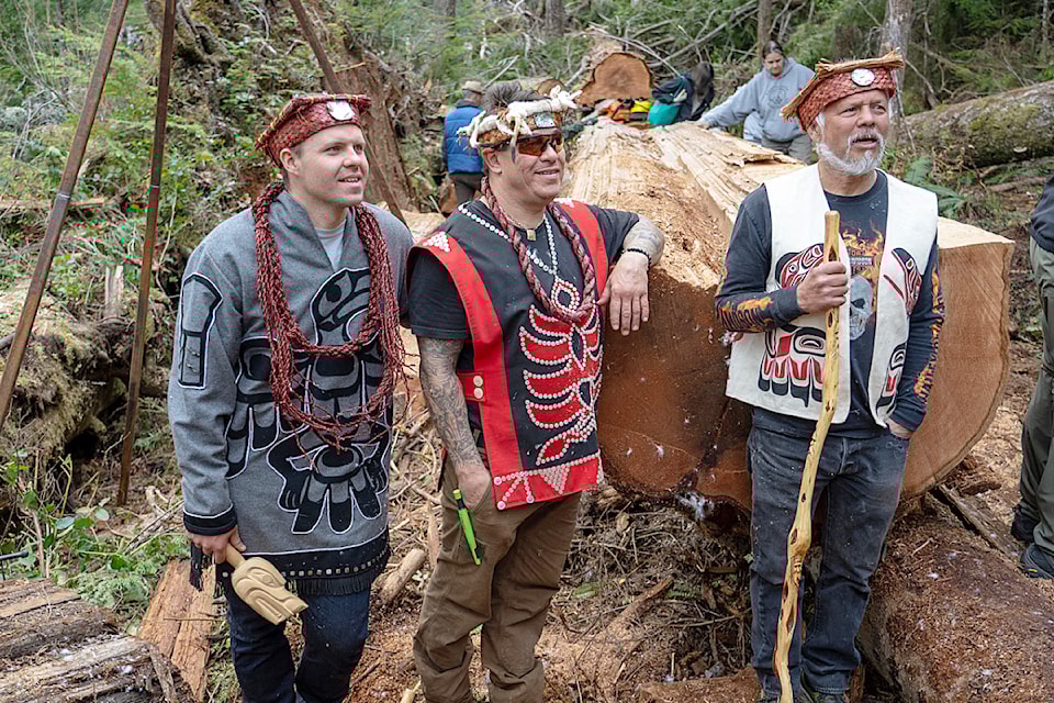 (From left) Karver Everson, Junior Henderson and Max Chickite pose beside the windfall cedar tree high in the H'kusuam Forest near Sayward that they will carve into a traditional First Nation canoe. 