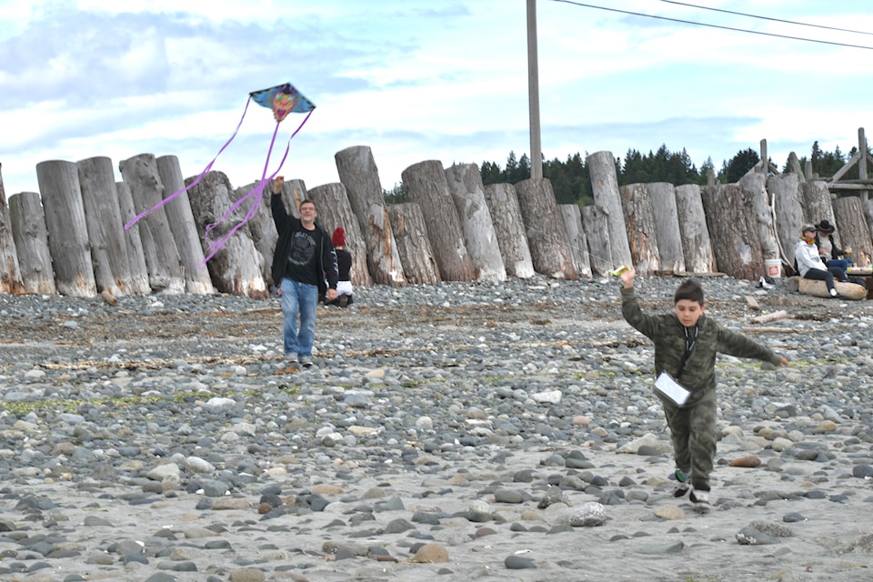 Jordan Caron (left) and his son Jordan Jr. fly a kite at the City of Courtenay's Father's Day Kite Fly event on Sunday. 