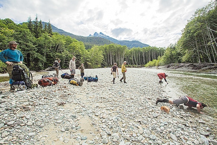 Hikers stop for a streamside break on the multi-day Bewell Valley hike.