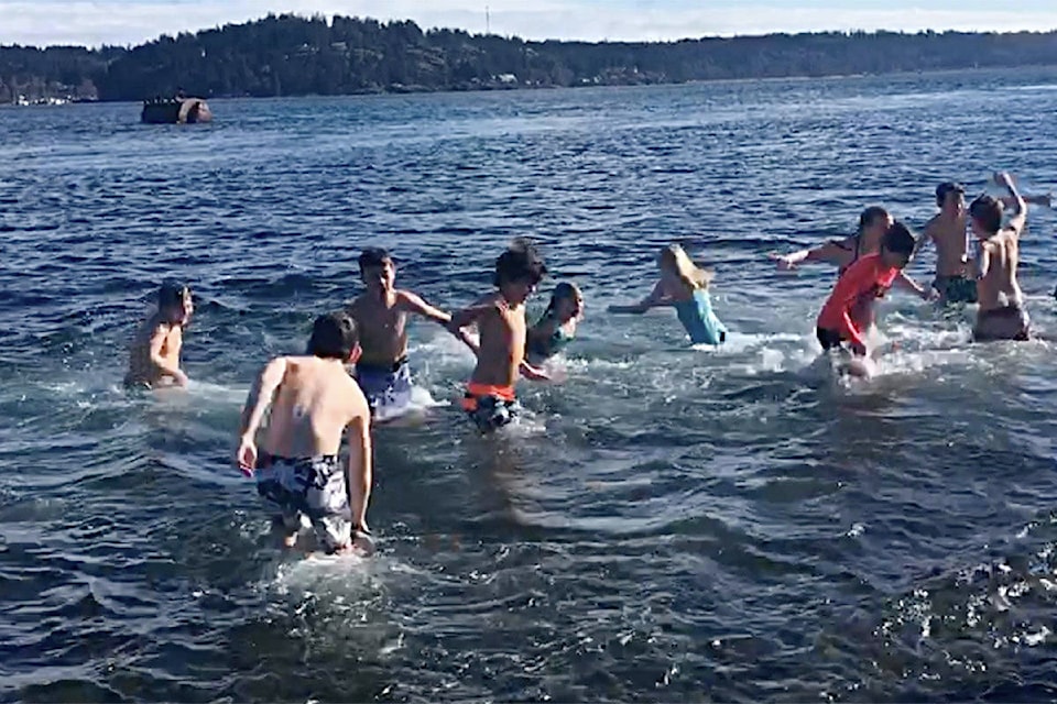 On Feb. 22, 2019, students from Ocean Grove Elementary jumped in the water off Tyee Spit as part of Sylas Thompson’s polar bear swim fundraiser for two local community groups. Screengrab from video by David Gordon Koch/Campbell River Mirror