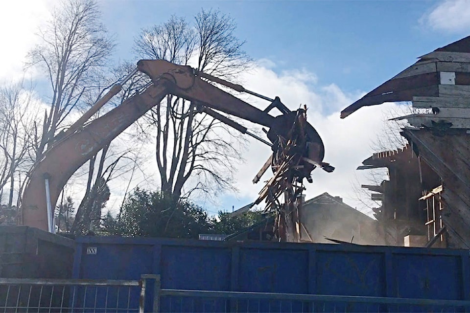 Workers demolished a boarded-up house on Fir Street on Friday to make room for a new affordable housing project. Screengrab from video by David Gordon Koch/Campbell River Mirror