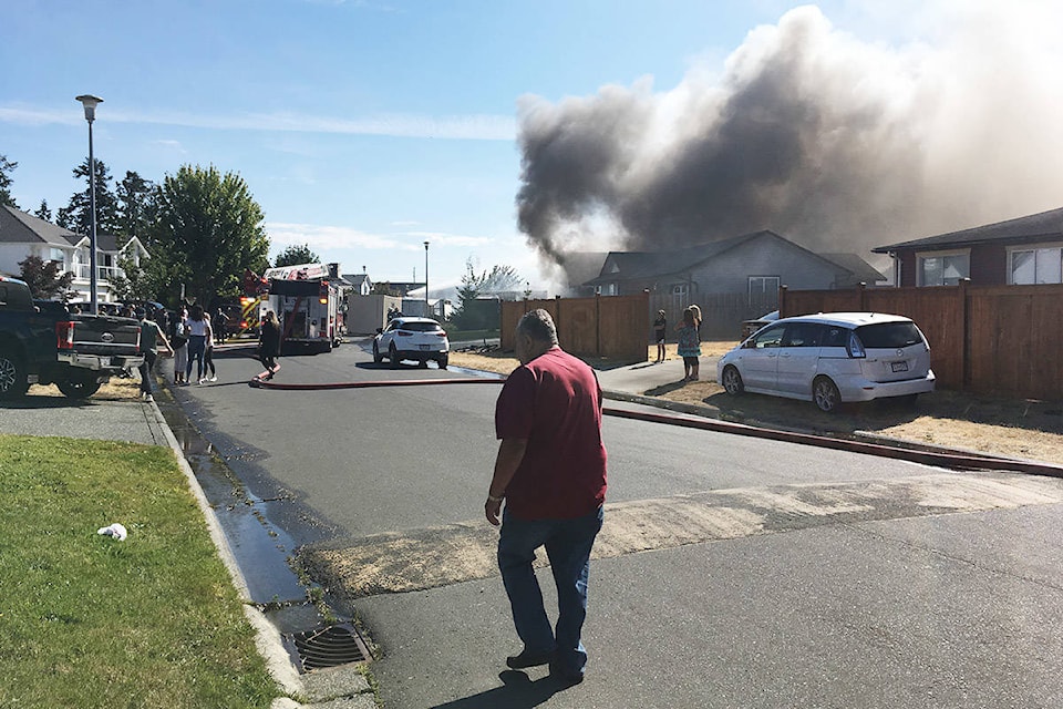 Heavy smoke billows from a house fire at the Wei Wai Kum reserve in Campbell River. The smoke was visible from miles away. Photo by David Gordon Koch/Campbell River Mirror