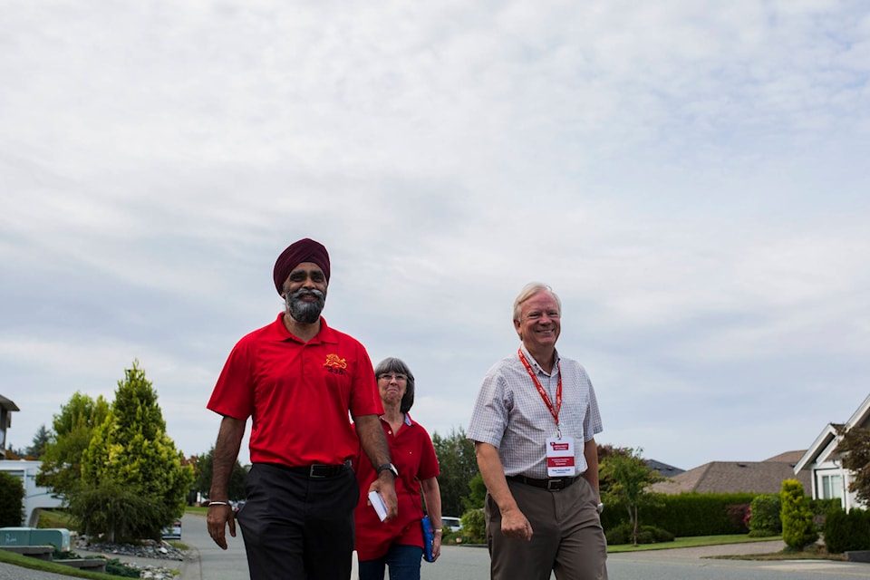 From left, Canadian Minister of National Defence Harjit Sajjan, Loretta Schwarzhoff and Liberal candidate Peter Schwarzhoff canvass in the Willow Point neighbourhood of Campbell River, B.C. on Aug. 22, 2019. Photo by Marissa Tiel/Campbell River Mirror