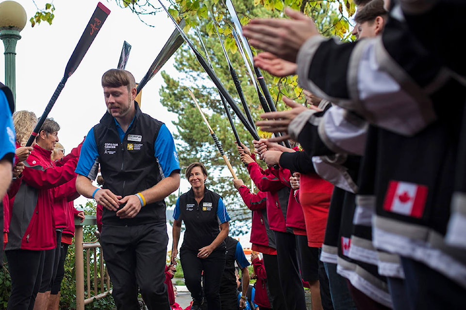 From left, Michael Smith of CFB Esquimalt Military Police and Kim Taylor of the Victoria Police Department are greeted by the River Spirit Dragon Boat Team and the Campbell River Storm as members of the 2019 Tour de Rock team arrive at Painters Lodge on Sept. 24, 2019 Photo by Marissa Tiel/Campbell River Mirror