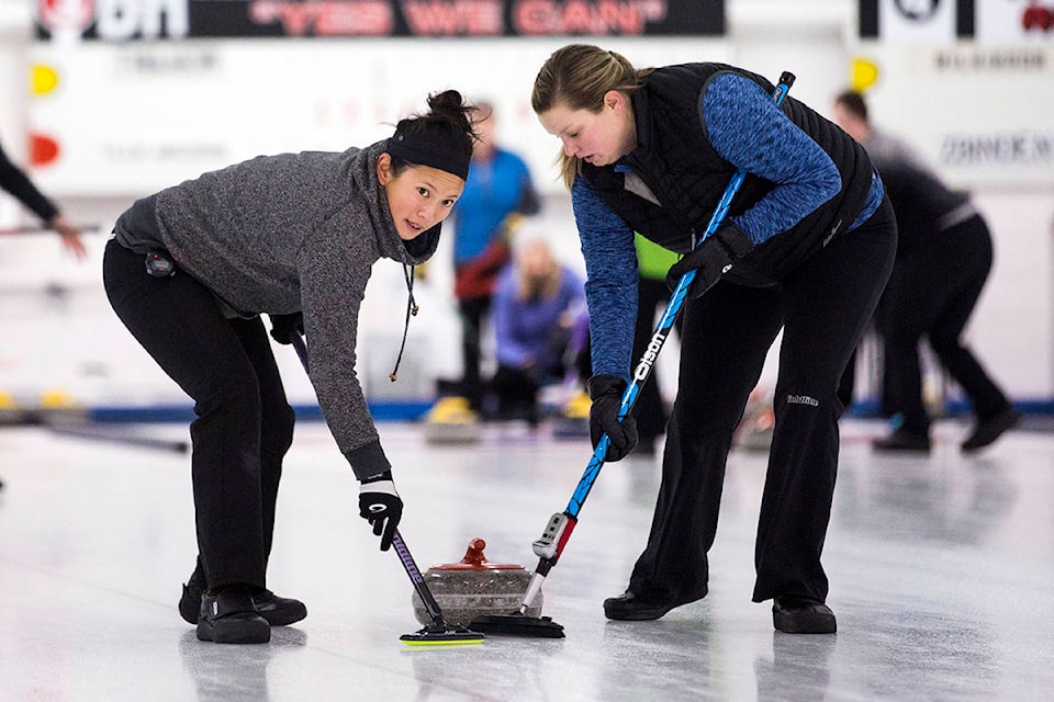From left, Cynthia Lu and Jami McMartin of the Kim Dennis rink sweep the rock down the ice during the Campbell River Curling Club’s ‘Women of Rock and Roll’ Ladies Open bonspiel on Nov. 10, 2019. Their team beat the Kim Jonsson rink to win the ‘A’ Title. Photo by Marissa Tiel/ Campbell River Mirror