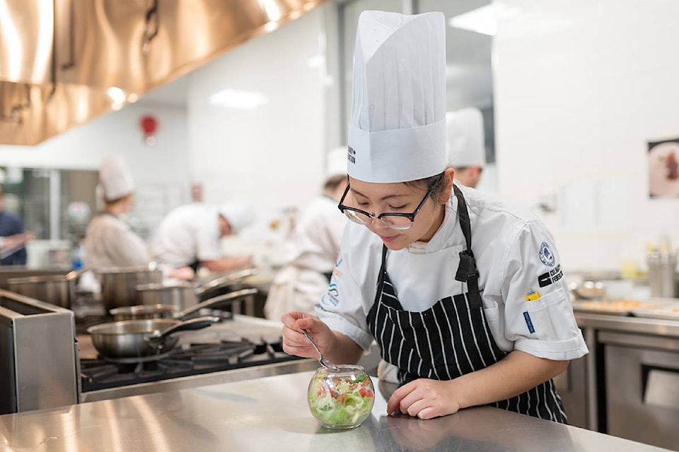 Tina Tang prepares a dish during a practice and fundraising event at North Island College in Campbell River, B.C. on Nov. 22, 2019. Photo by Lee Simmons/North Island College