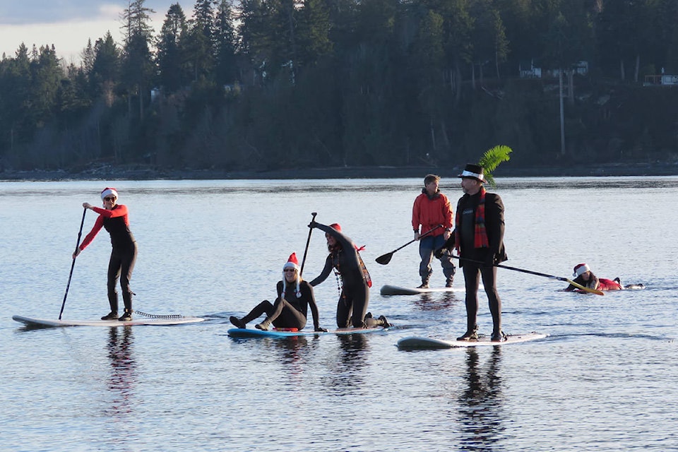Paddlers were treated to calm waters and sunshine during the annual Santa Paddle at Stories Beach on Dec. 15, 2019. Photo by Billie Harlow
