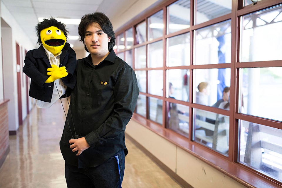 Ben Bellosillo poses for a photo with a puppet he made while creating the puppets for Timberline Secondary’s upcoming musical production of Avenue Q. Bellosillo, who graduated last year, made all of the puppets from scratch for the production last summer. Photo by Marissa Tiel/Campbell River Mirror