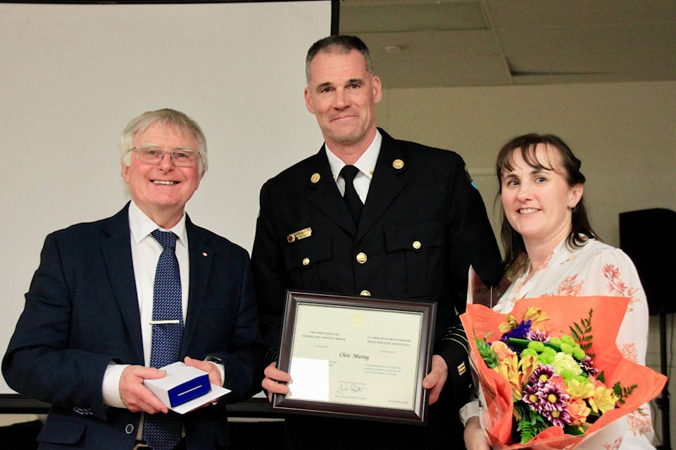 CVRD Area C Director Edwin Grieve presenting Deputy Chief Chris Murray with his federal 20-year Exemplary Service medal.