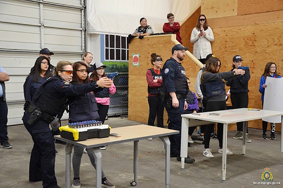 Students learning about fire arms and practicing with paint simunition rounds on a paper target (not seen in picture). RCMP photo