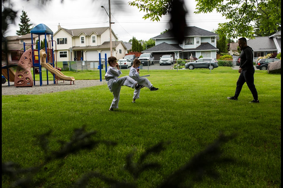 From left, Carter and Korey Reise practise their karate technique with sensei Nigel Nikolaisen in a park in the southend of Campbell River, B.C. on May 20, 2020. Photo by Marissa Tiel РCampbell River Mirror