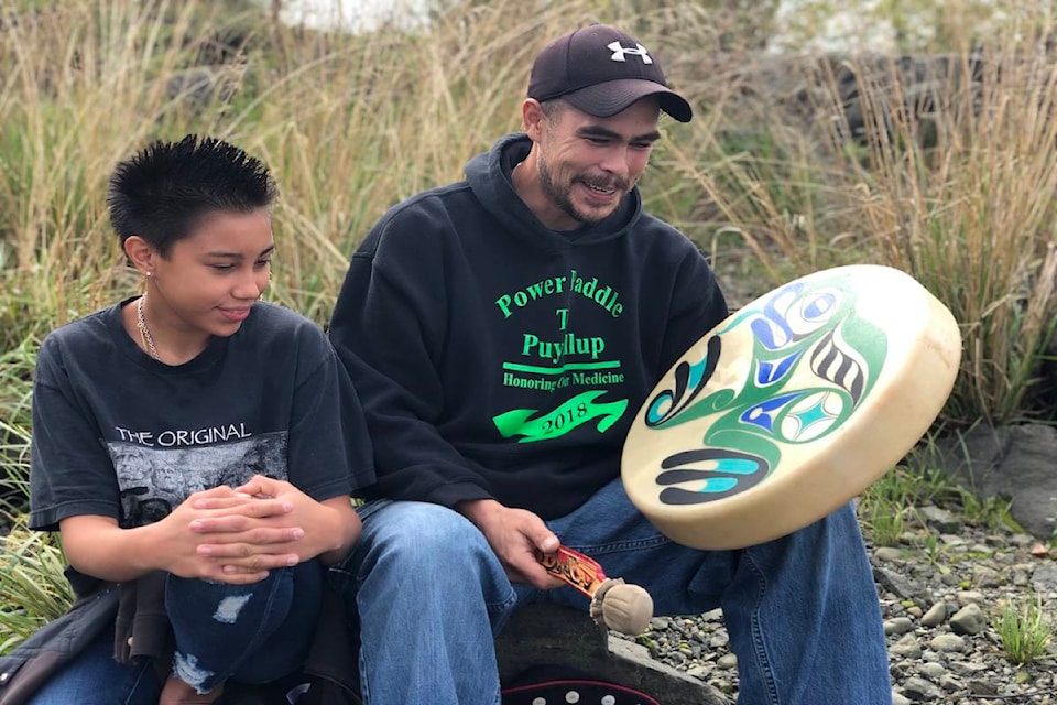 Lyric John-Cliffe and Cory Cliffe sing a traditional Laichkwiltach canoe song by the Campbell River Estuary. Photo by Binny Paul/Campbell River Mirror