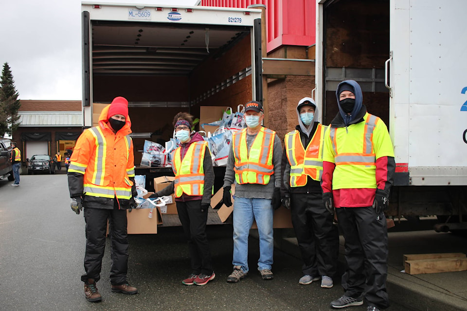 From left are volunteers Steve Lackey, Monica Strebel, Walt Bukauskas, Cory Bukauskas and Kyle Bukauskas as they fill up one of many cars for the Knights of Columbus Hamper Drive. Photo by Marc Kitteringham, Campbell River Mirror