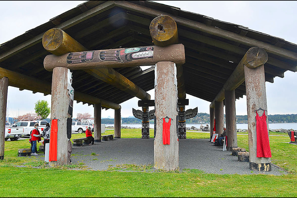 Red dresses hang on the Longhouse at Campbell River’s Robert Ostler Park on May 5, which is designated as Red Dress Day to commemorate murdered and missing Indigenous women and girls. A gathering at the Longhouse was held to mark the day and the MMWIG. Photo by Alistair Taylor/Campbell River Mirror