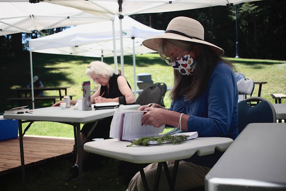 Colleen Jay (left) and Joy Dawson sketch some local plants in the afternoon on Saturday. Photo by Marc Kitteringham / Campbell River Mirror