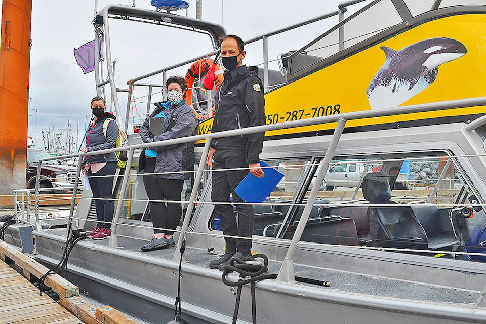 Geoff Duntan (right), captain of Discovery Marine Safaris’ MV Tenacious III, addresses the passengers of the June 6 Sonora Island historic tour while naturalist Kaitlin Paquette (centre) and the Museum at Campbell River’s historian/tour guide Erika Anderson listen on. Photo by Alistair Taylor/Campbell River Mirror