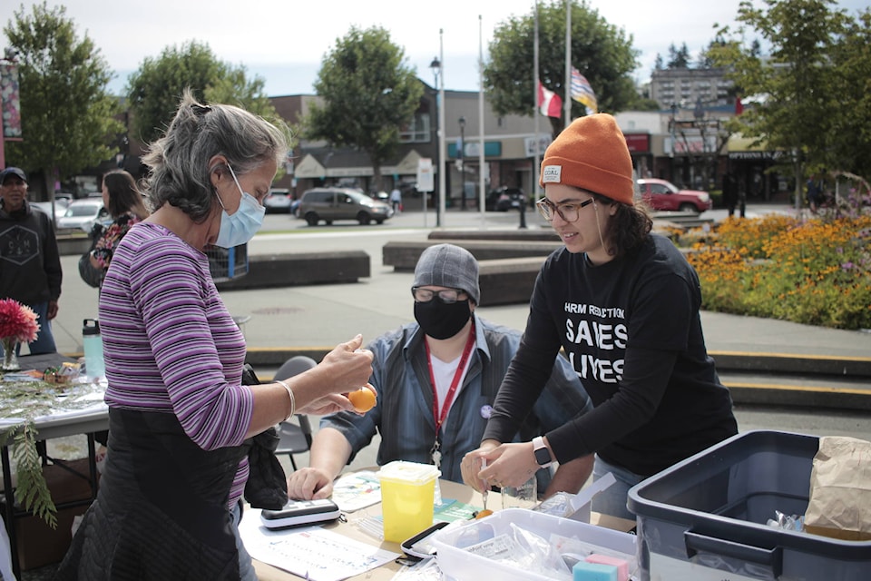 Lisa Alemany-Kunzler (left) learns how to administer Naloxone from Trevor Cardinell and Amy Criss from AVI. Photo by Marc Kitteringham / Campbell River Mirror