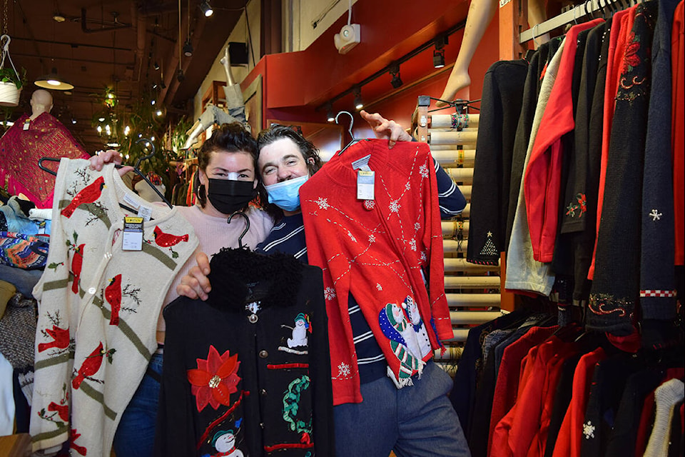 The Patch owner Christopher Shurety (right) and colleague Morgan (left) display some of their favourites of this year’s “ugly” Christmas sweater collection. (Kiernan Green/News Staff)