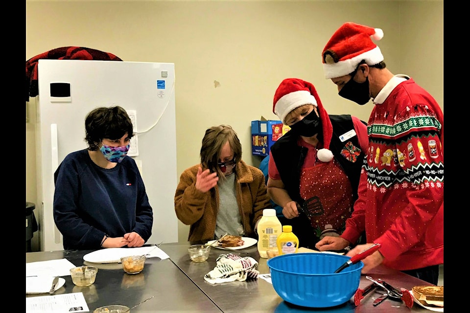 Class participants and instructor Heather Wood have fun cooking up tasty treats during a Giggling Gourmet class. Courtesy of City of Campbell River.