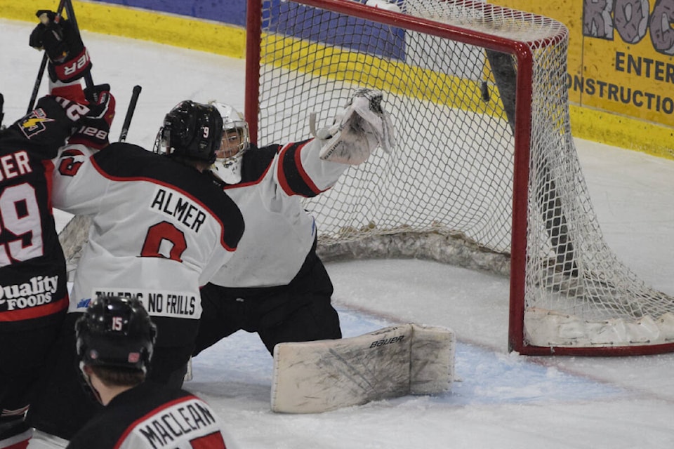 Port Alberni Bombers goaltender Callum Tung makes a desperate save in the first period of Game 4 against the Campbell River Storm. (ELENA RARDON / ALBERNI VALLEY NEWS)