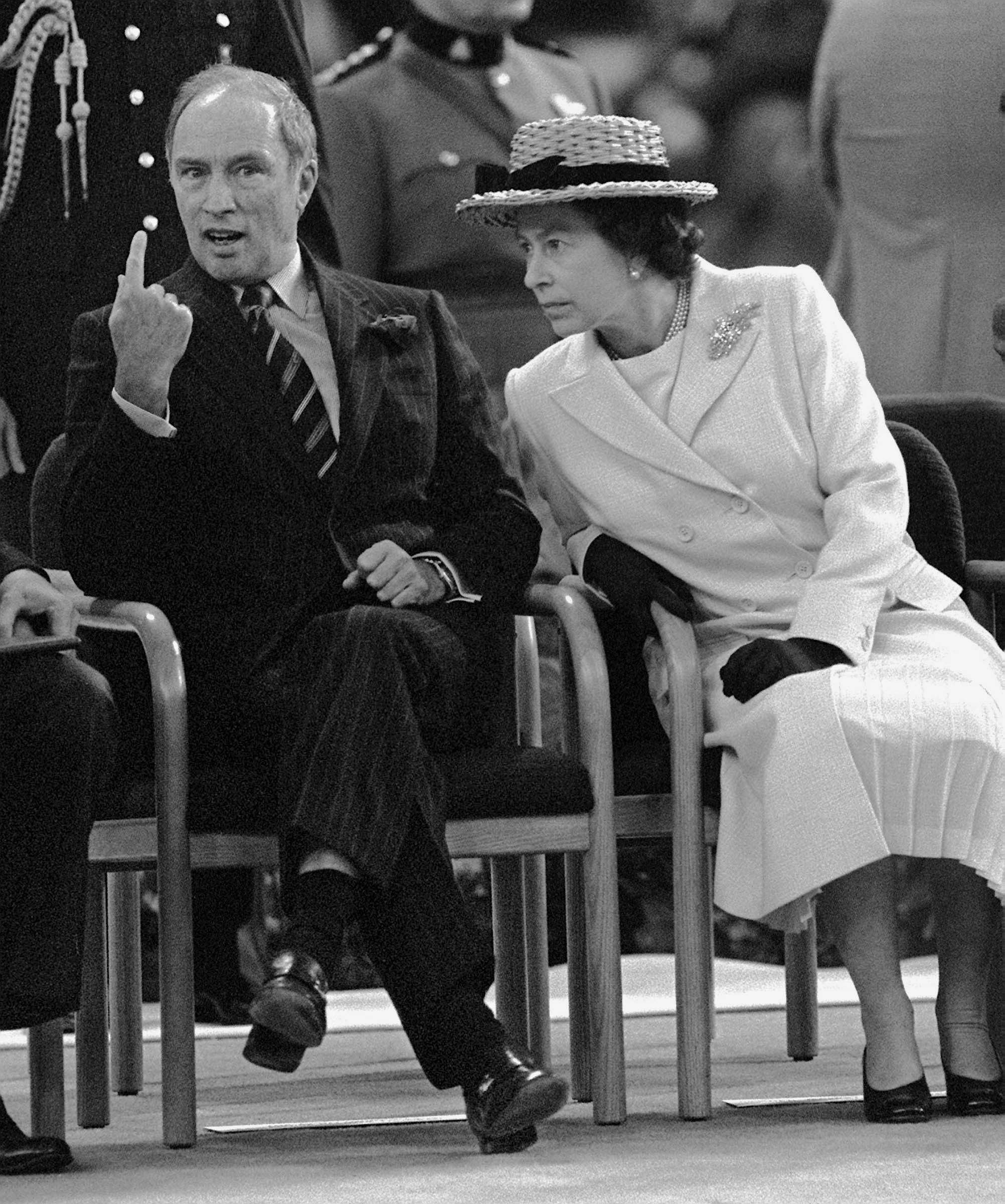 Queen Elizabeth listens while then-Prime Minister Pierre Trudeau explains something to her prior to the EXPO 86 invitational ceremoy that the Queen read from the people of Canada inviting the people of the world here in 86. The ceremony took place inside the domed BC Stadium. (CP PHOTO)