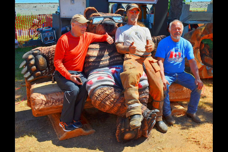 Photo by Alistair Taylor/Campbell River Mirror After four days in the hot sun with chainsaws buzzing and sawdust flying, Transformations on the Shore carvers (from left) Bill McDonald, Dan Richey and festival founder Max Chickite pose for a picture Saturday, June 25 on Richey’s 2022 creation. The Transformations on The Shore Carving Festival returned to Frank James Park in a reduced form after the pandemic-induced hiatus. Photo by Alistair Taylor/Campbell River Mirror