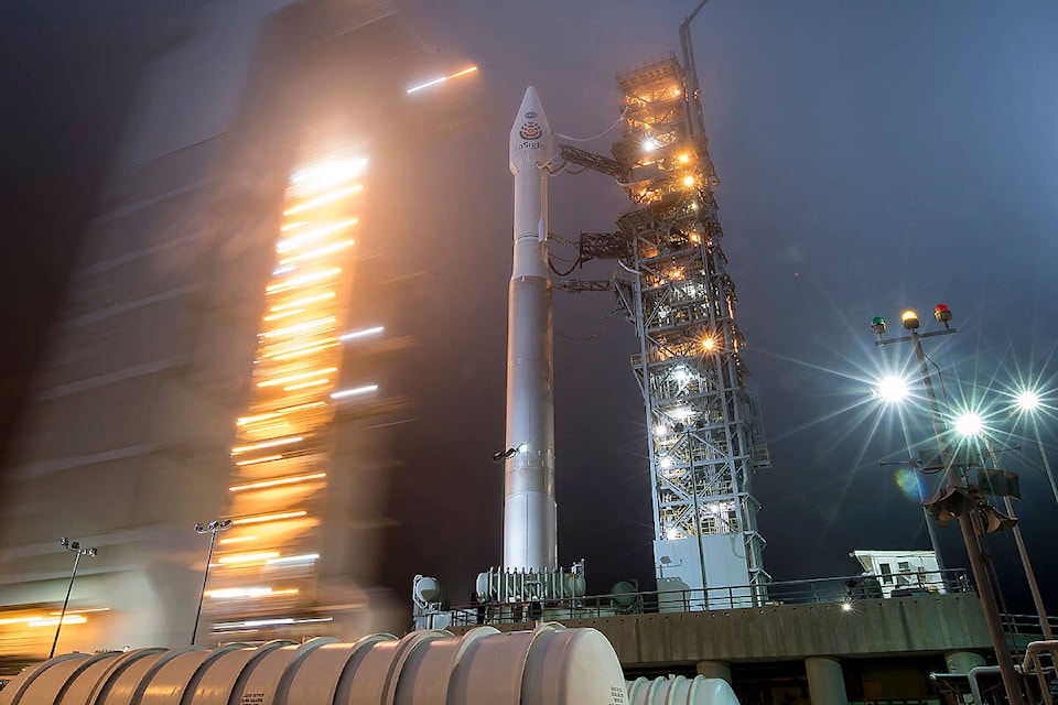 In this May 4, 2018 photo provided by NASA, the mobile service tower is rolled back to reveal the United Launch Alliance Atlas-V rocket with NASA’s InSight spacecraft onboard at Vandenberg Air Force Base, Calif. NASA’s three-legged, one-armed geologist known as InSight makes its grand entrance through the rose-tinted Martian skies on Monday, Nov. 26, 2018. (Bill Ingalls/NASA via AP)