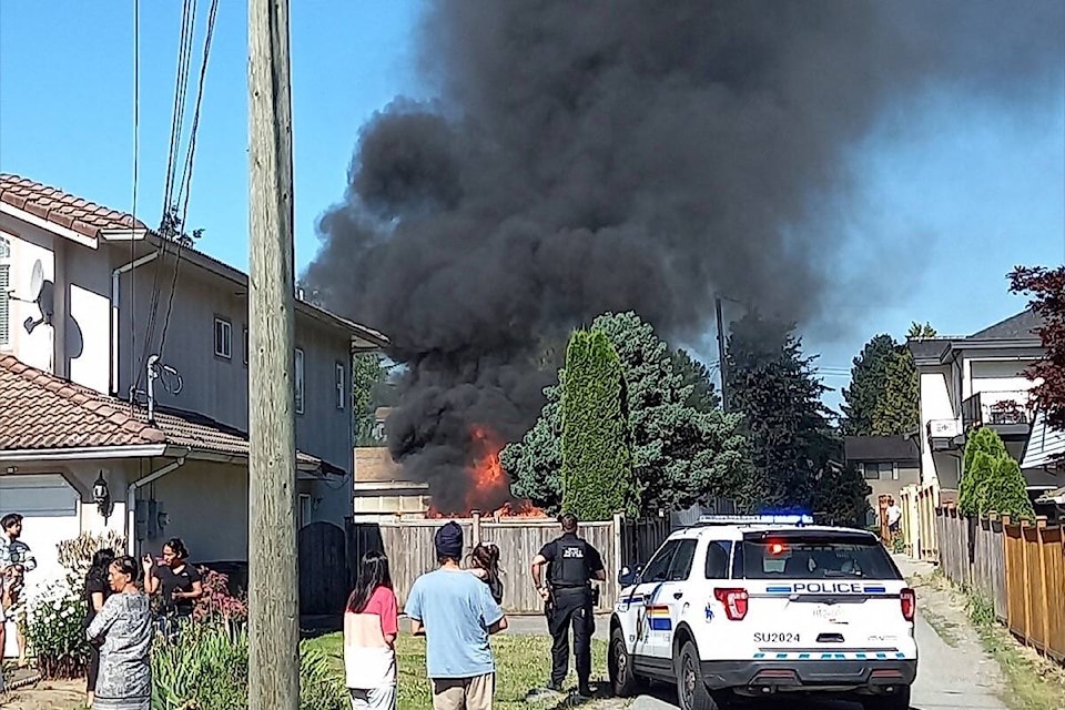 Police, bystanders at scene of car fire in Newton after man was shot in the 8200-block of 128 Street. (Submitted photo)
