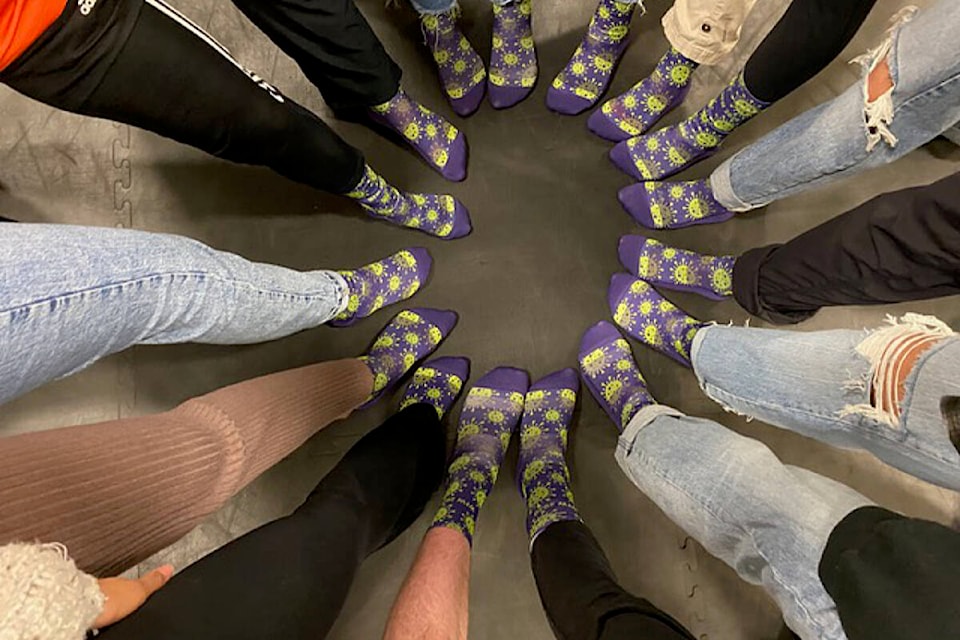 Volunteers show off their matching Women for Women socks. Photo courtesy Shelagh Germyn