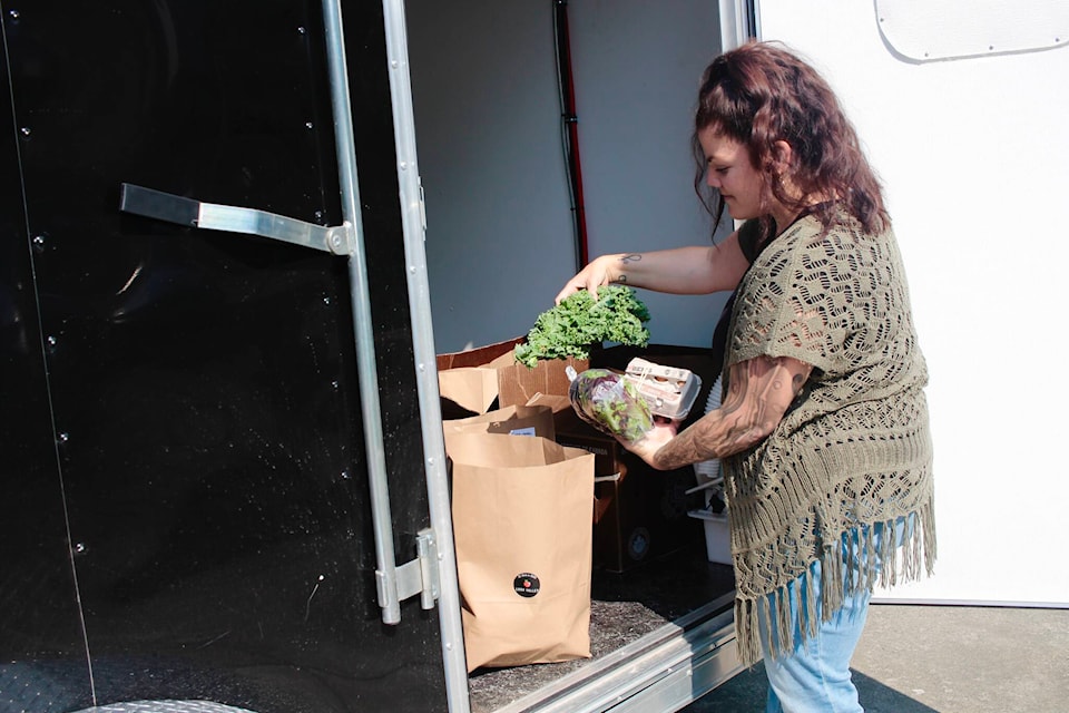 Greenways Land Trust Food Security Coordinator Callie Bouchard prepares one of the LUSH Valley-partnered Good Food Boxes. Photo by Marc Kitteringham/Campbell River Mirror