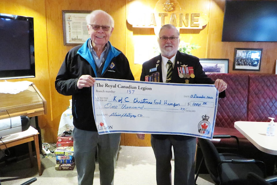 Campbell River Royal Canadian Legion Branch 137’s President Alain Chatigny CD presents a cheque of $1,000 to Mike Beston of the Knights of Columbus for their Christmas Hamper. Photo contributed