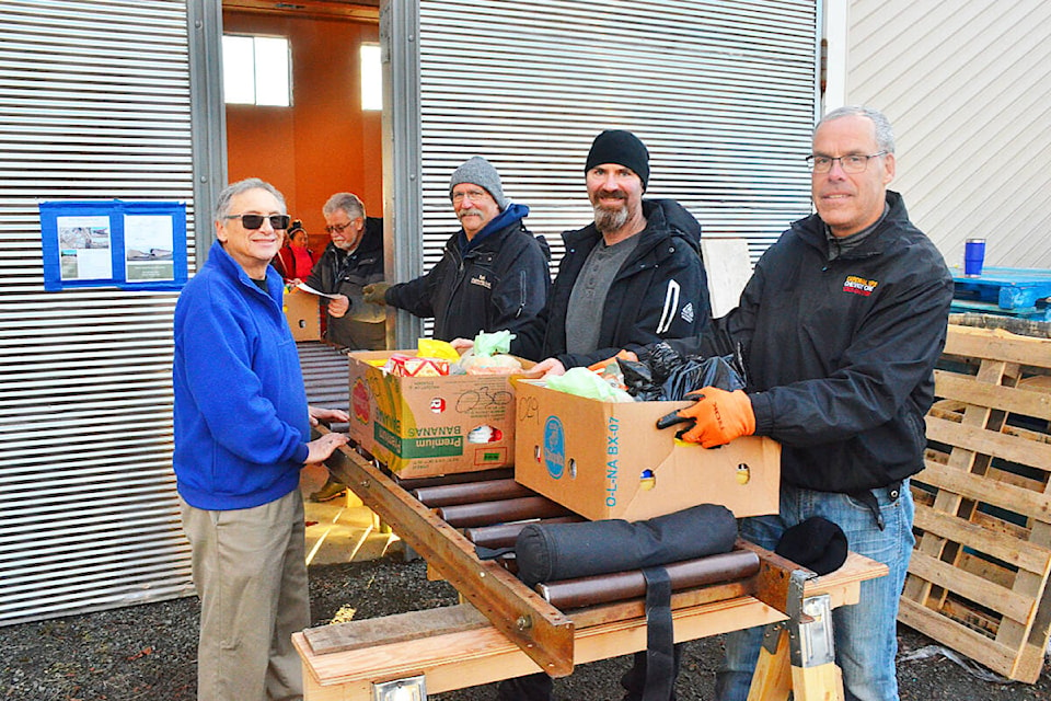 The last link between the hamper sorting and loading stage and the volunteer delivery drivers are Knights of Columbus Christmas Hamper volunteers Steve Niesen, Rick Anglin, Glen Piotrofsky and Tim Hansen. They were just four of many volunteers preparing hampers and delivering them to families in need on Saturday, Dec. 17, 2022. Photo by Alistair Taylor/Campbell River Mirror