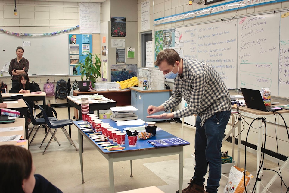 Kyle Fitzpatrick from Greenways Land Trust shows students at Southgate Middle School how to plant seeds in their starter pots. Photo by Marc Kitteringham/Campbell River Mirror