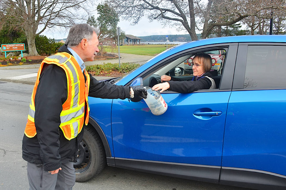 Rotarian Craig Gillis accepts a donation from a driver during the annual March for Kids on Saturday, Feb. 11 at Shopper’s Row and Island Highway. Rotarians spread throughout Campbell River to collect change and debit card donations to raise money for children’s health needs in the Campbell River area. Photo by Alistair Taylor/Campbell River Mirror