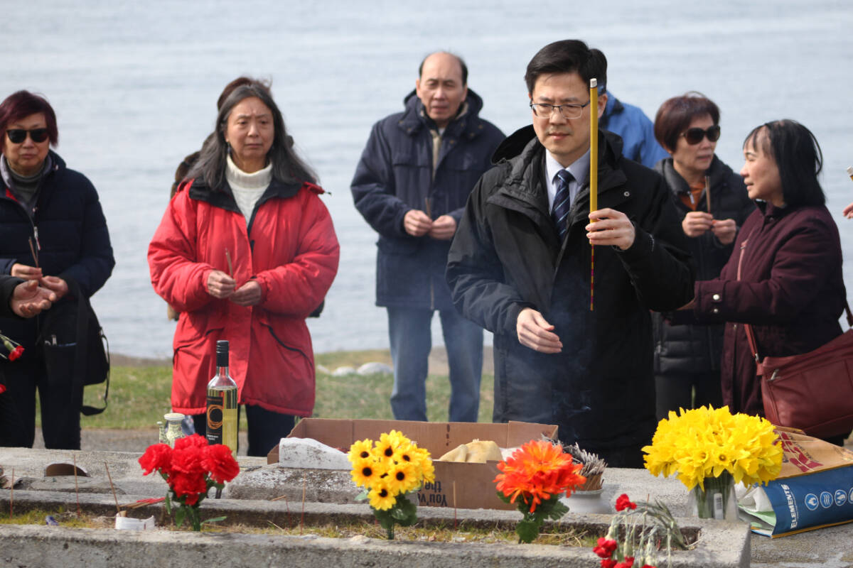 Members of Victorias Chinese diaspora community lay flowers and light incense in celebration of Qingming at the Chinese Cemetery at Harling Point in Oak Bay April 5. (Austin Westphal/News Staff)