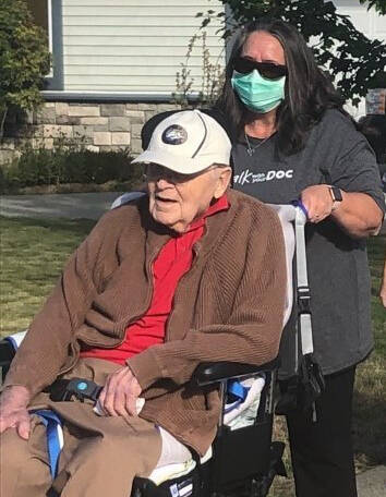 A Golden Grove resident enjoys a walk in the spring sun with his care aid.