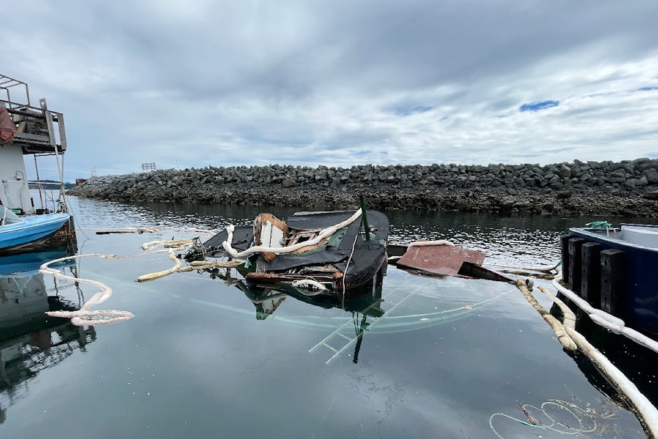 The scent of gasoline drifts from the sunken 50-foot tugboat at Fishermans Wharf in Campbell River. The abandoned boat went down on Monday after spending years in the harbour.