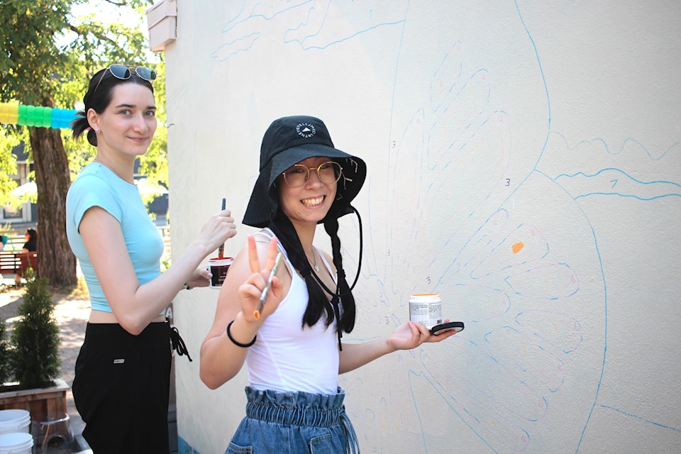 Gabrielle Thibault and Chloe Hataley take a break from their work.